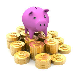 A pink pig standing on top of gold coins