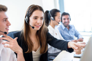 call centre agent being trained by a team leader