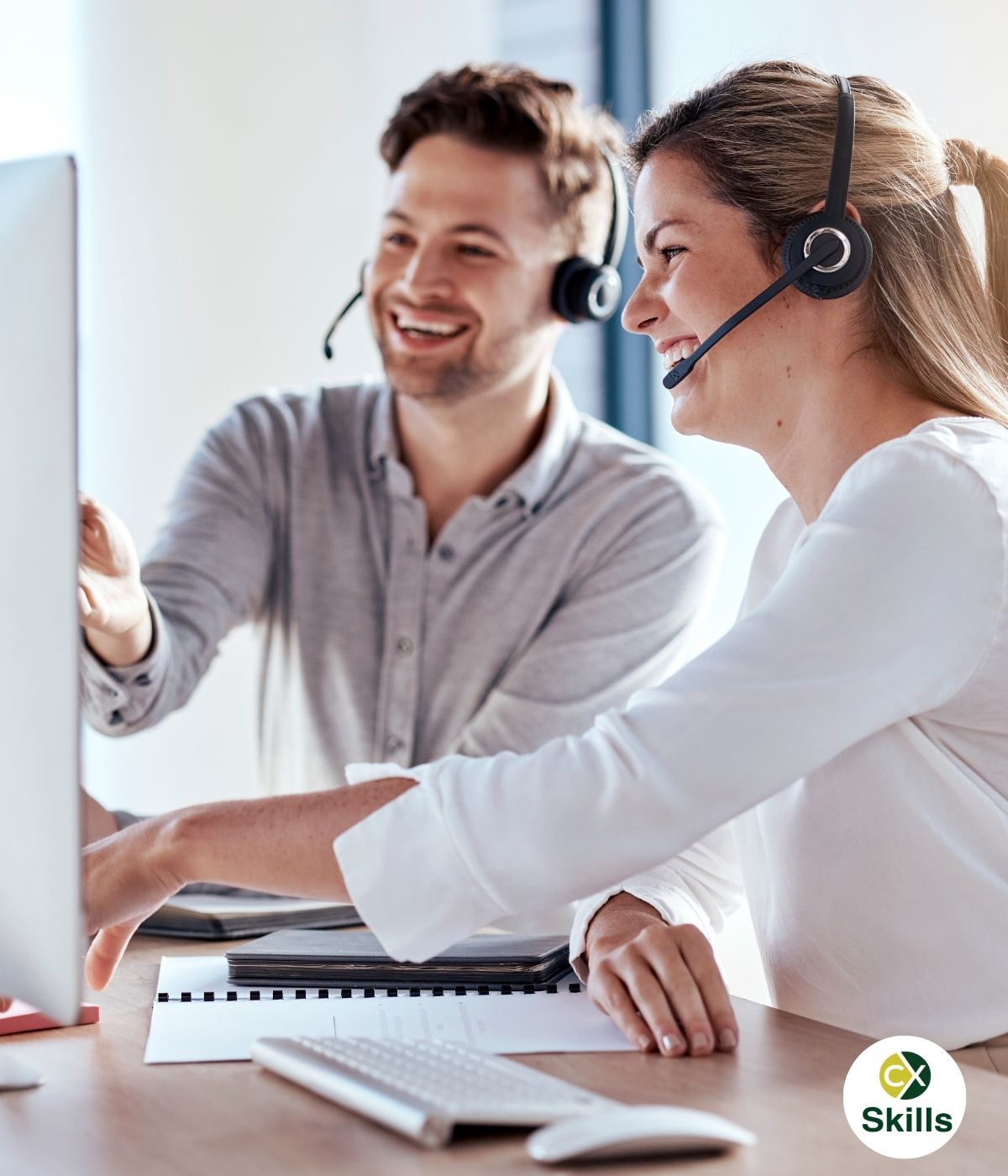People in a contact centre training session wearing headsets