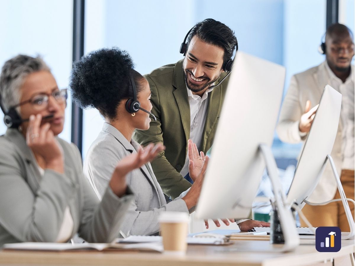 Contact centre team talking through performance at their desks