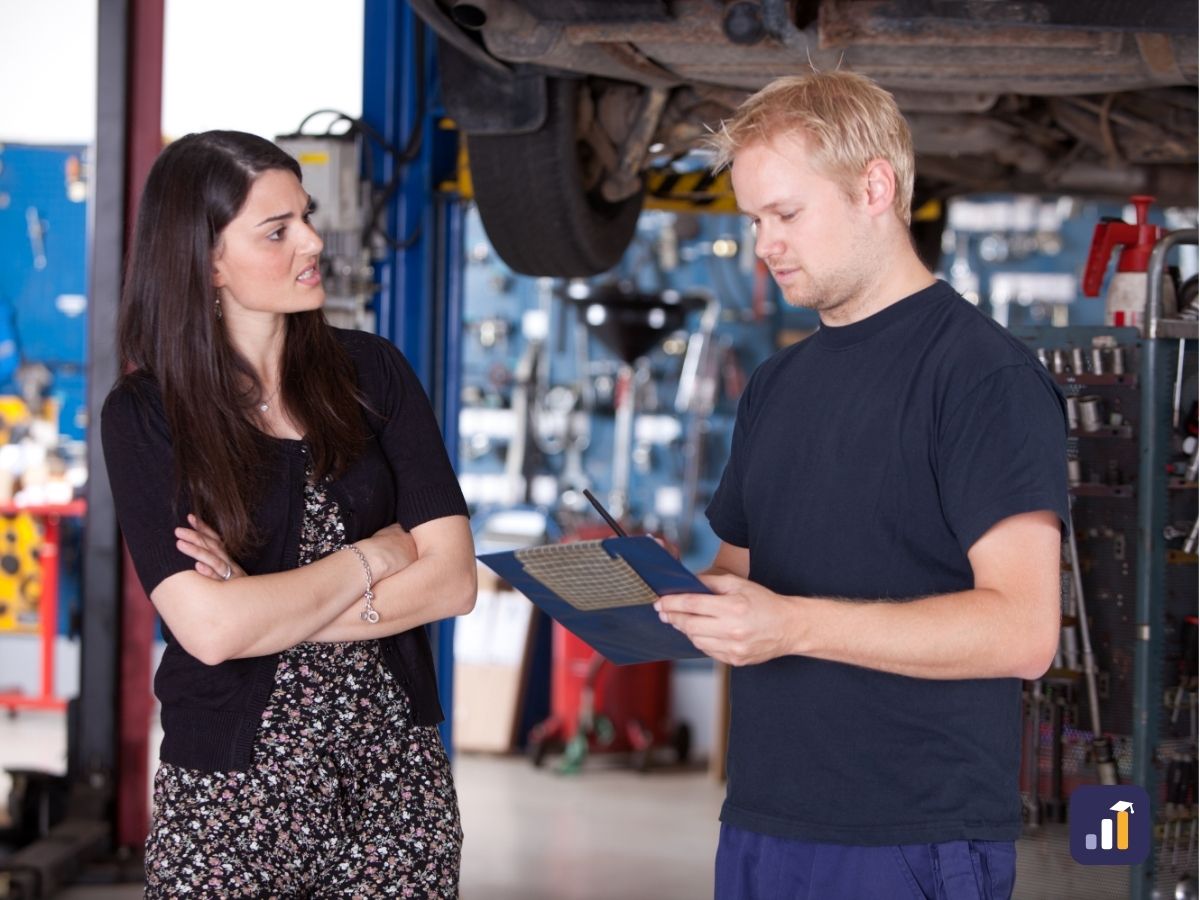 Service advisor calmly handling an unhappy customer in a workshop