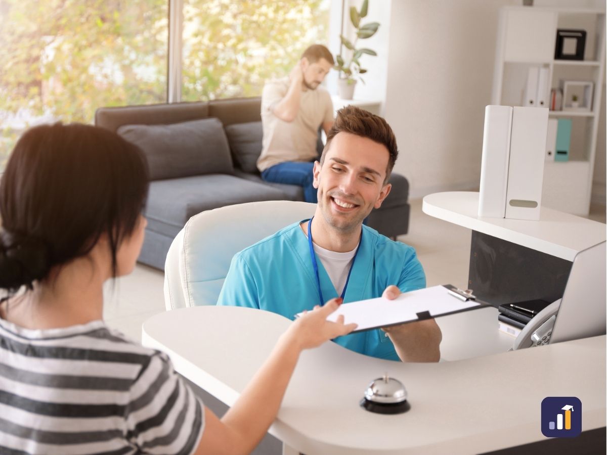 Smiling receptionist handing a clipboard to a visitor at the front desk