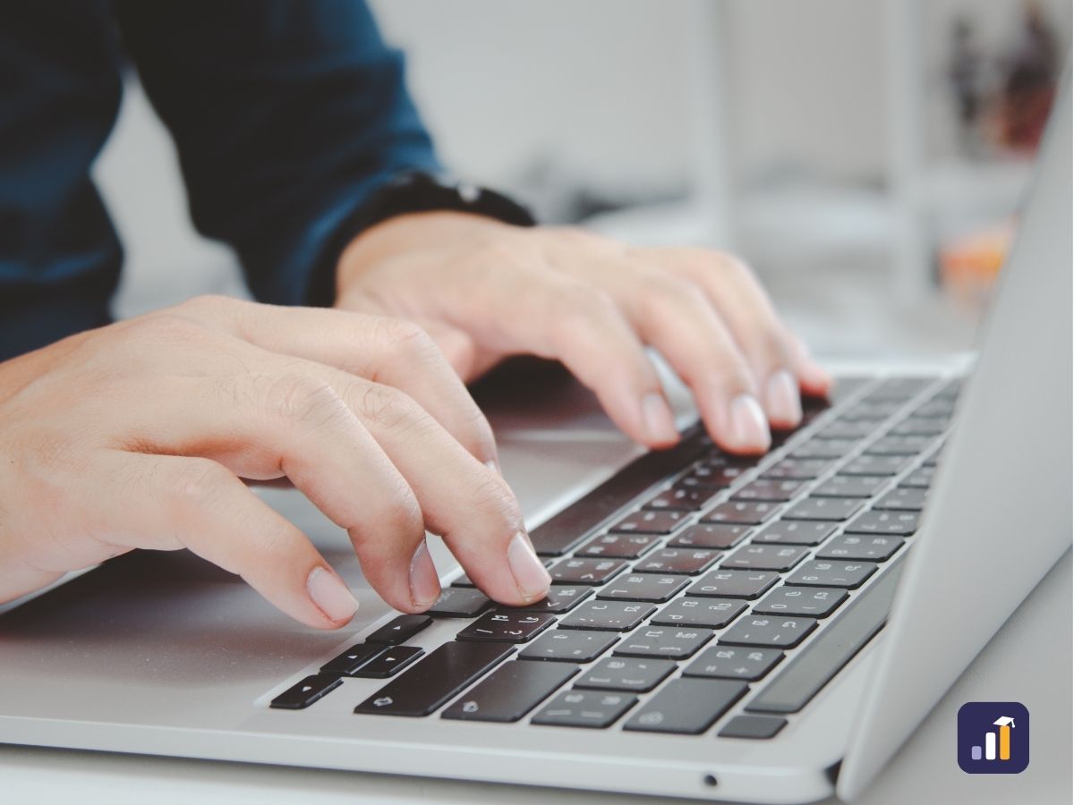 Customer service team member typing a reply to a customer email on a laptop