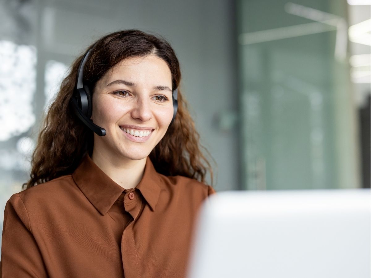Customer service professional with a headset on a phone call with a customer